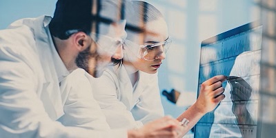 two scientists looking at a screen