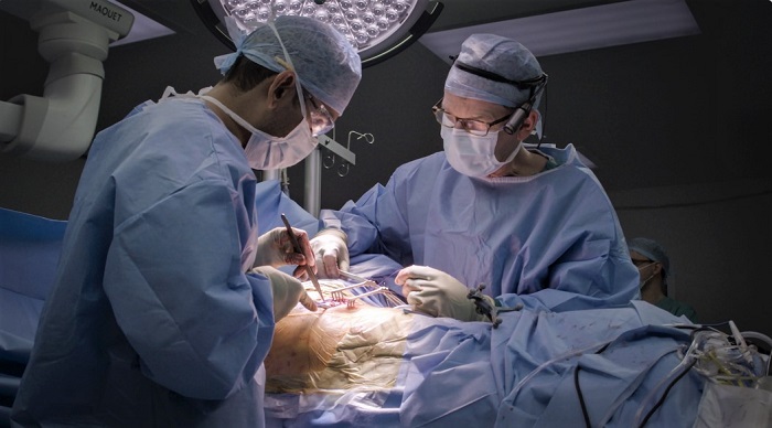 Jibin Francis and Rod Laing in the operating theatre