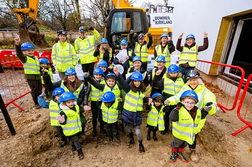 Pupils at Bishop Creighton Academy help ro bury a time capsule at the construction site of the new ARU Peterborough universit