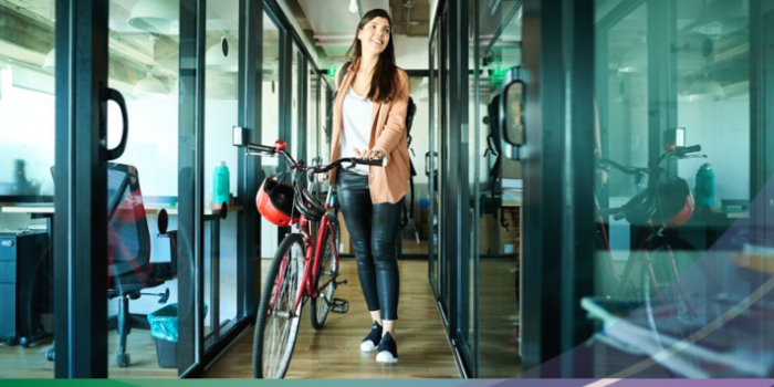 woman arriving in an office with a bicycle