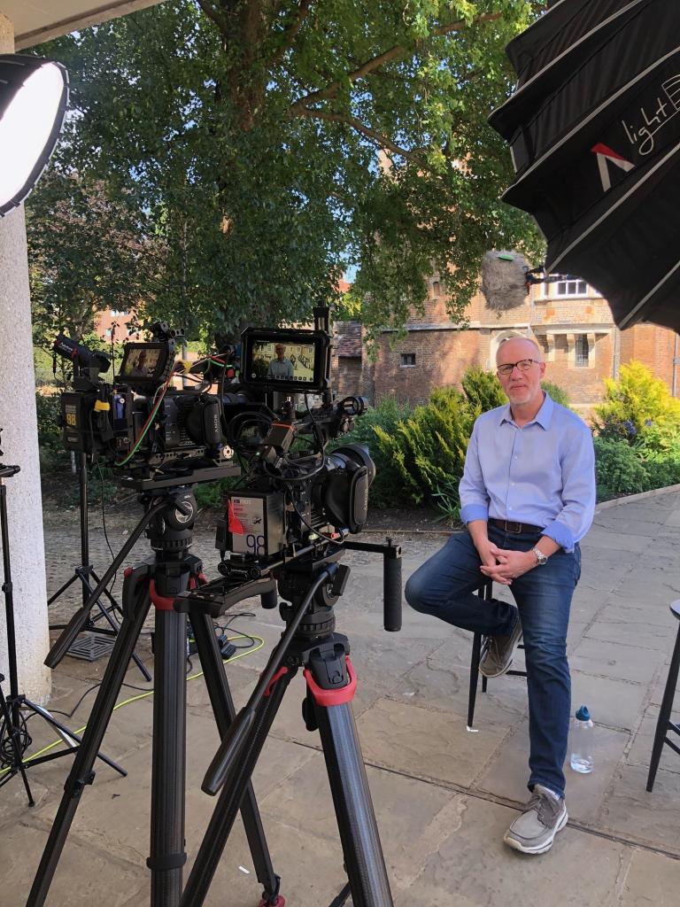 Simon surrounded by video cameras and lights