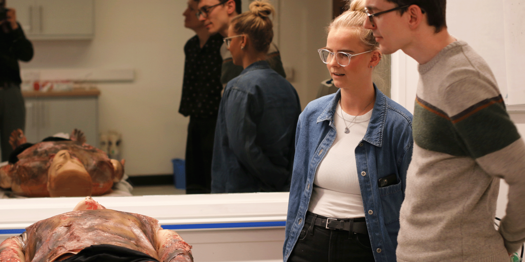 two Team Consulting employees at the NHS burn simulation course 