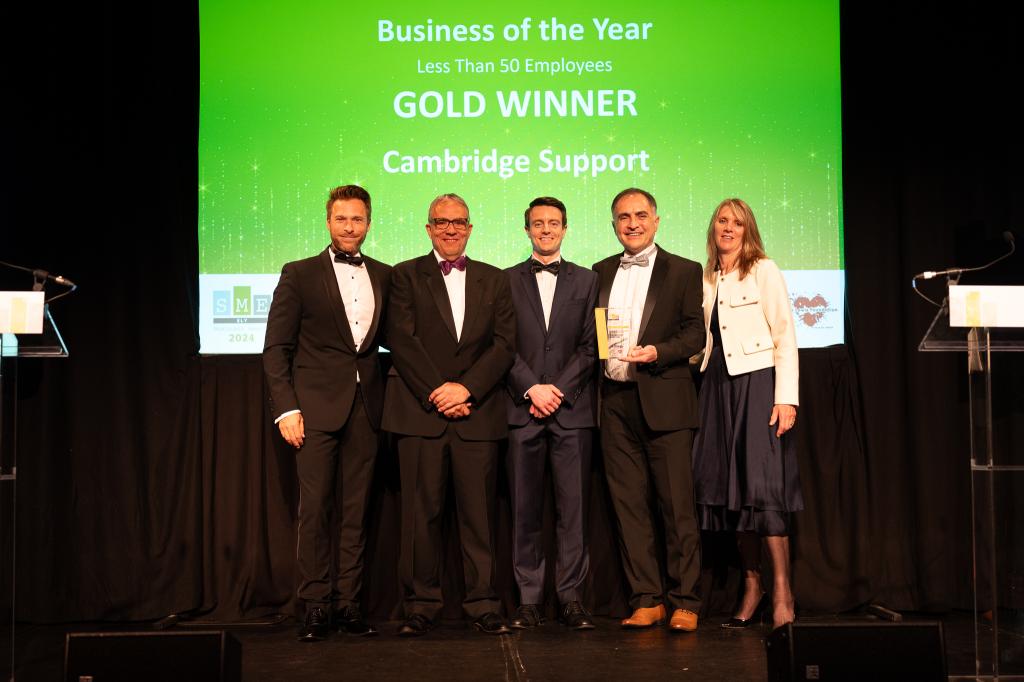 Phil, Helen and Glen from Cambridge Support, collecting the gold award for Business of the Year (Less than 50 employees) at the SME Ely Business Awards.