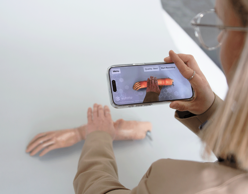 woman scanning mannequin arm using virtual reality app developed by Team Consulting