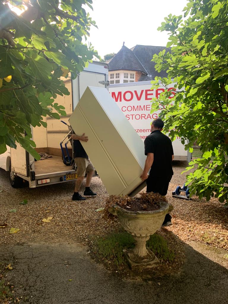 Removal men lifting heavy item