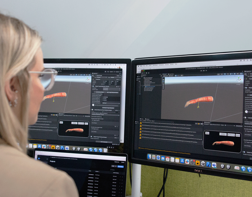 woman working on 3D scanning software on computers