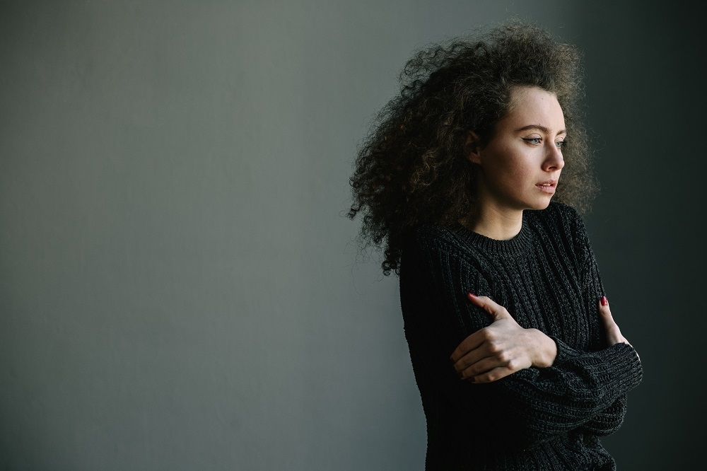 sad woman looking through the window