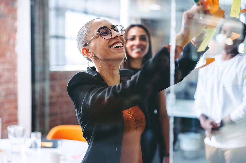 woman in the office doing a task and smiling