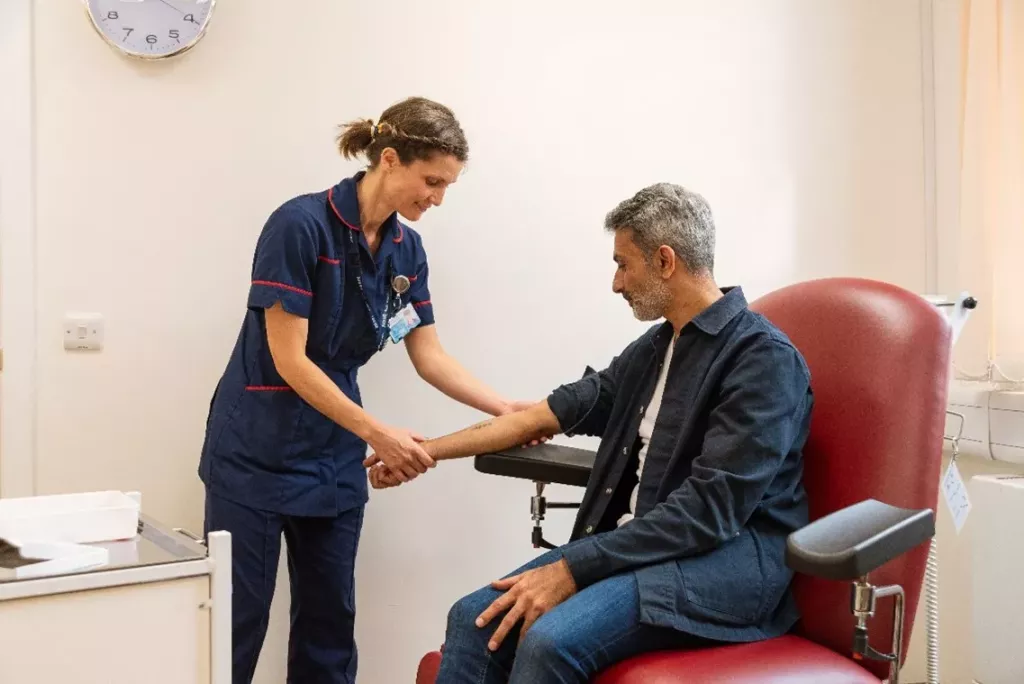 Nurse holding a volunteer's arm