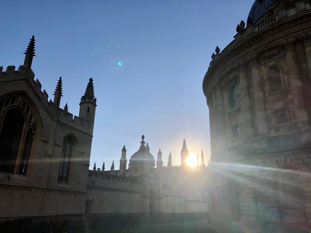 Sun rising behind historic college