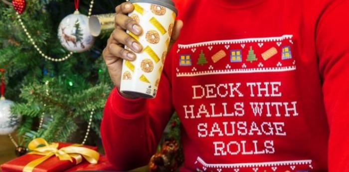 Festive jumper saying 'Deck the halls with sausage rolls'
