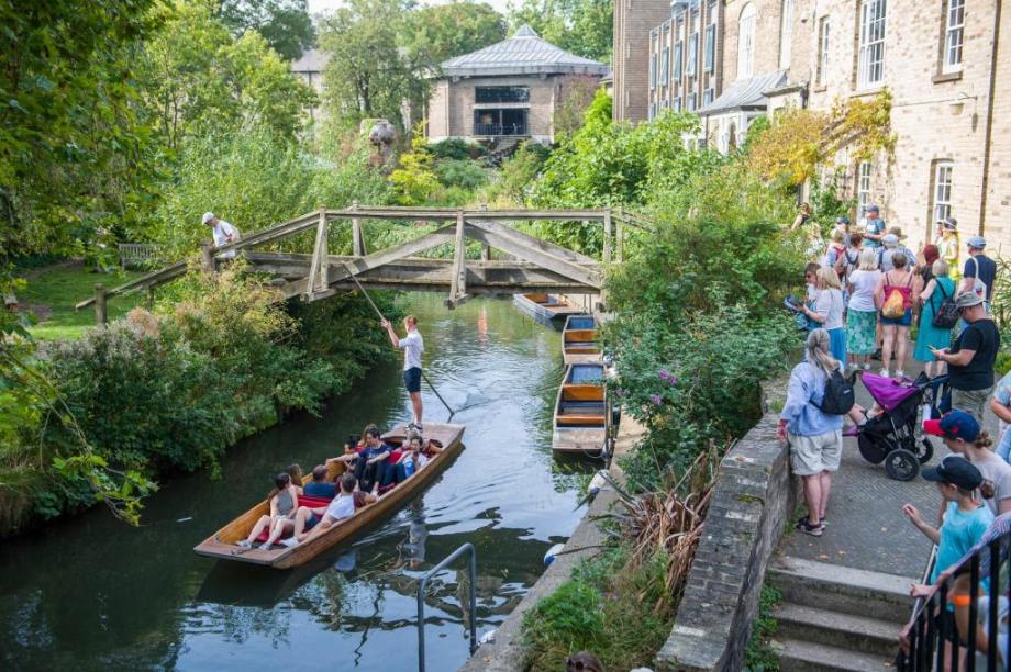 Punts on the river with people around 