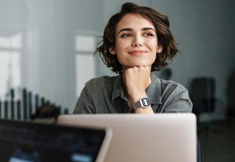 Smiling woman sitting at a computer