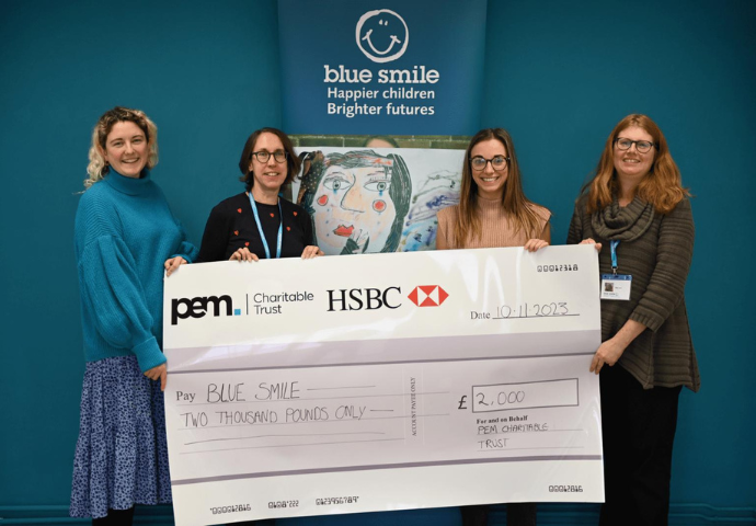 ladies holding a large cheque