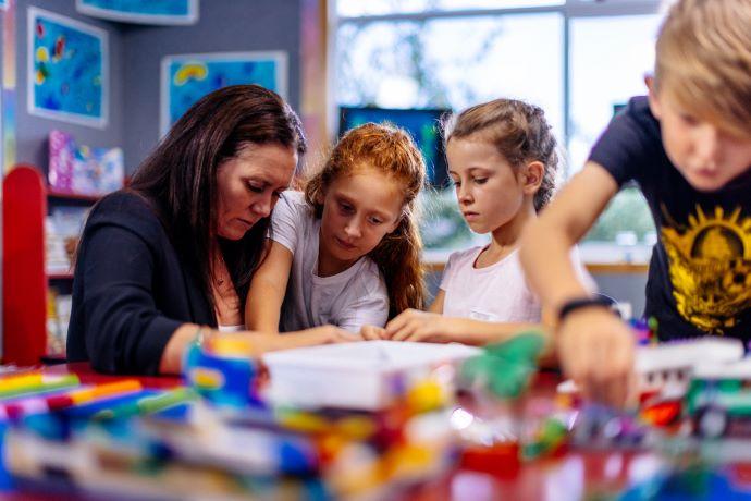 A teacher and students using the Brick-by-Brick® programme 