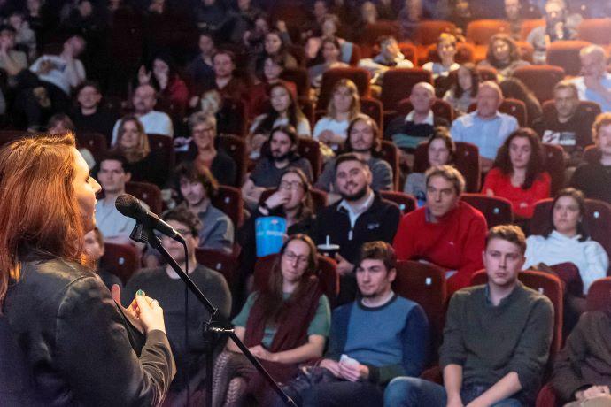 female talking to an audience 