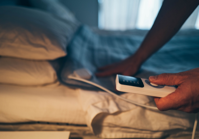 Using Electric Blanket In Winter During Energy Crisis Stock Photo