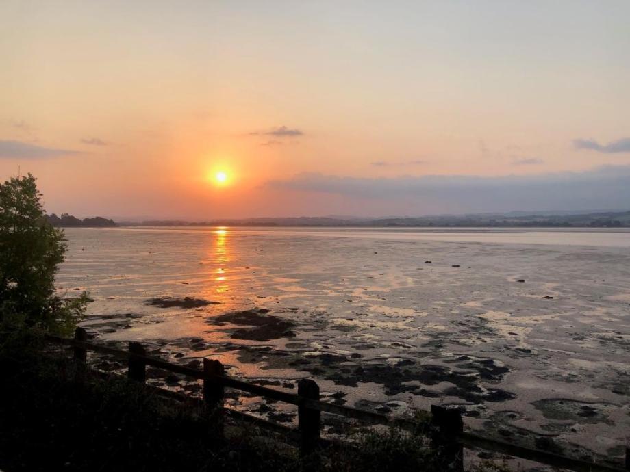 The sun setting over a beautiful river