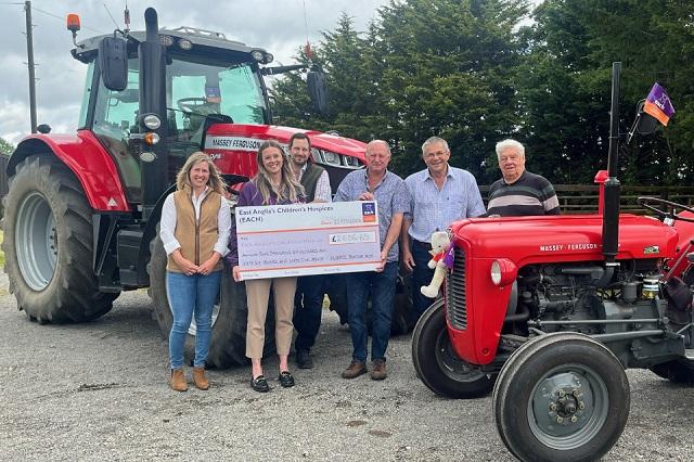 Ellie Miller and Peter Jarrett hold the cheque aloft alongside members of Ruperts family and volunteer David Boulger