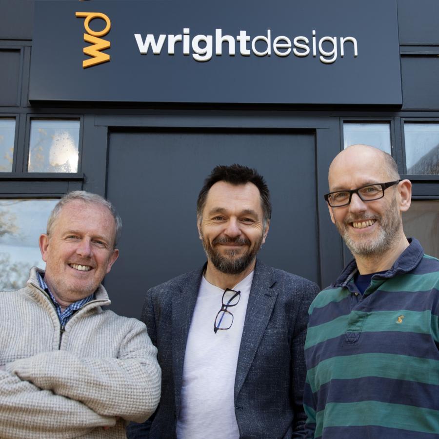 Matt Wright and Dan Walton, founders of Wright Design, stand with Steve Baker, managing director of Fen Technology, outside Wright Design's Cambridge office.