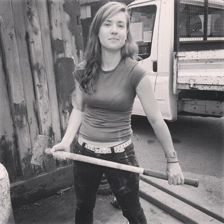 Hannah Cox holding a sledge hammer