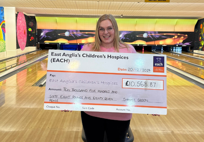 lady holding a big cheque 