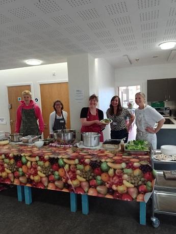 Bea Brown and Cambridge Sustainable Food volunteers with food to serve at Cambridge holiday lunch programme