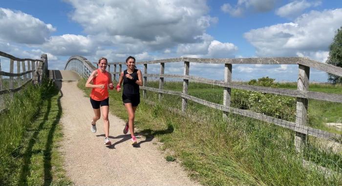 Kerry Bullen, 48, and Troi Baxter, 26, running in handcuffs