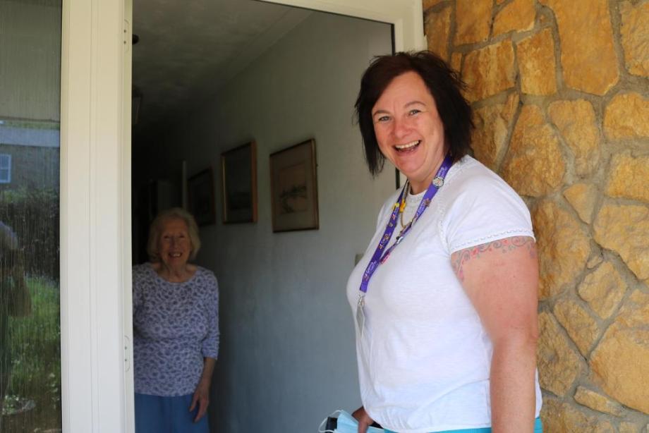 Kerry at the front door of a woman needing homecare for her husband