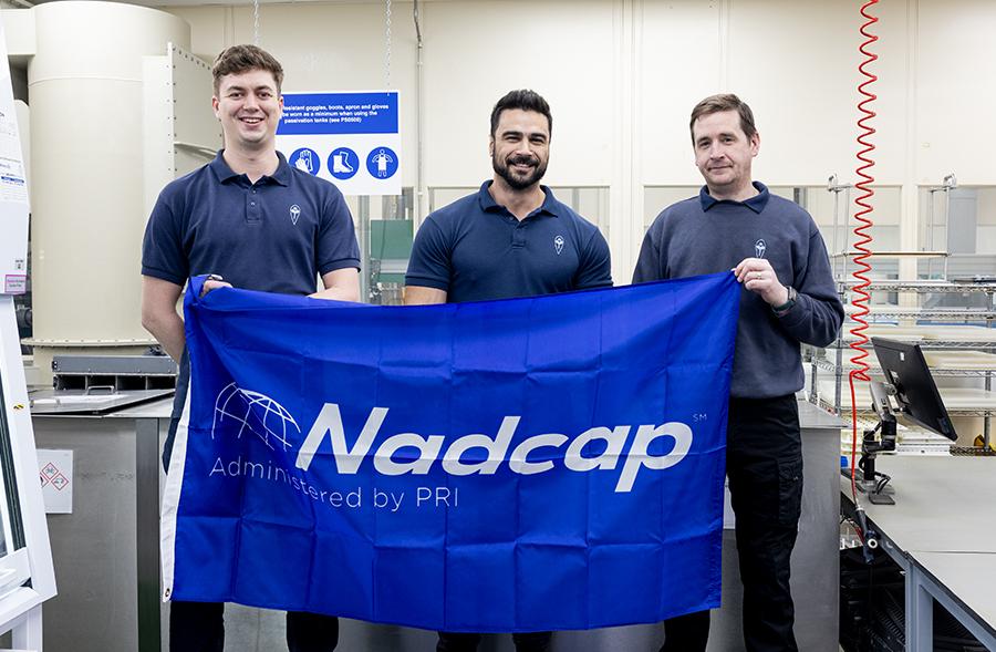 Team holding NADCAP flag 