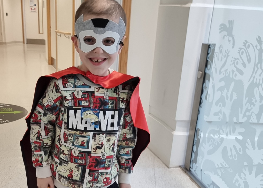 Little boy with super hero mask on in hospital