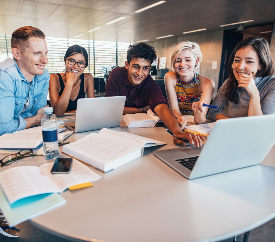 A group of five students seeing their UCAS results on a laptop screen