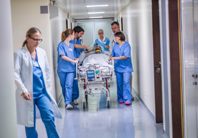 nurses moving a patient 