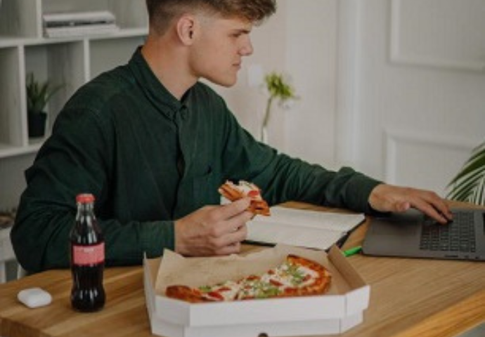 young male eating pizza