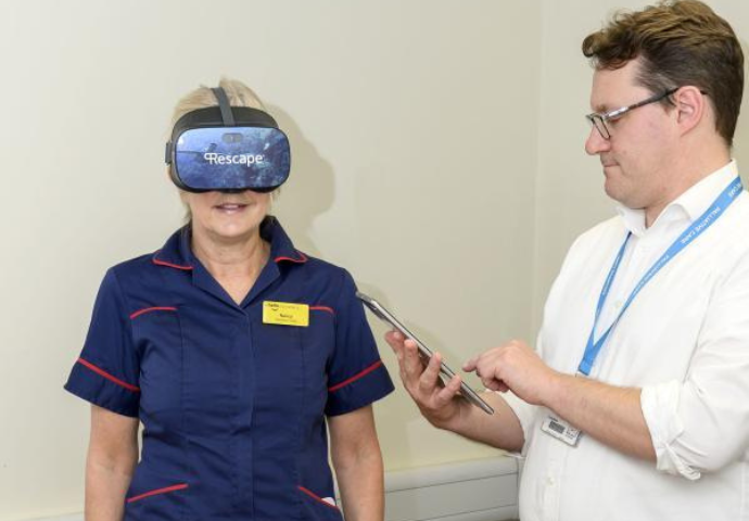 Nancy Burridge and Dr Ben Clark from the palliative team demonstrating the virtual reality headset