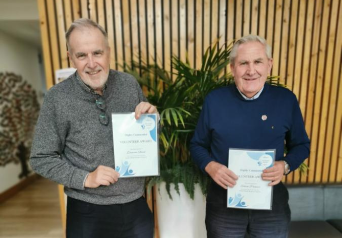 2 males holding certificates 