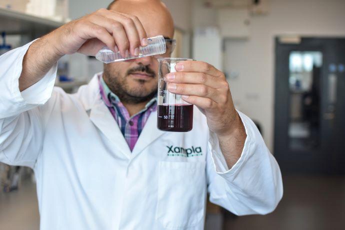 A man holding a test tube 