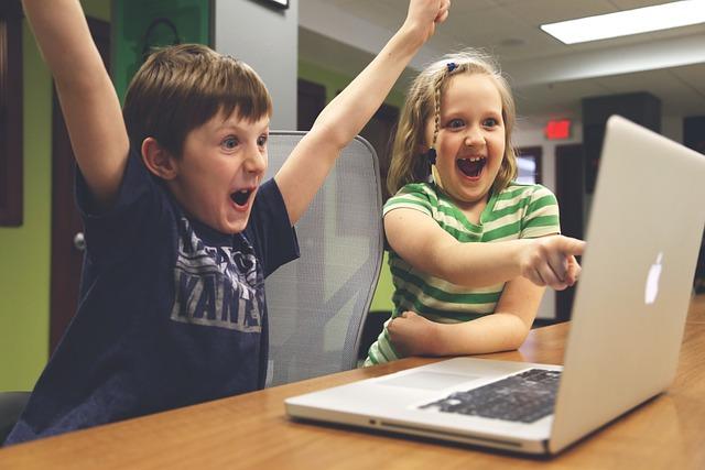 Children celebrating over a laptop