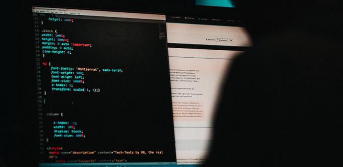   Someone programming a website in HTML  Credit: Mika Baumeister on Unsplash