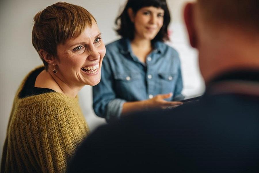 Smiling woman having a meeting with her colleagues