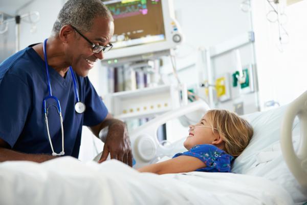 Male nurse with young patient
