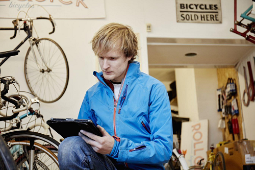 man with bicycles and paperwork