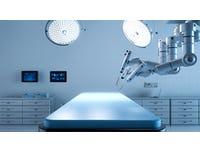 empty operating table wirth robotic surgery arm in view above it