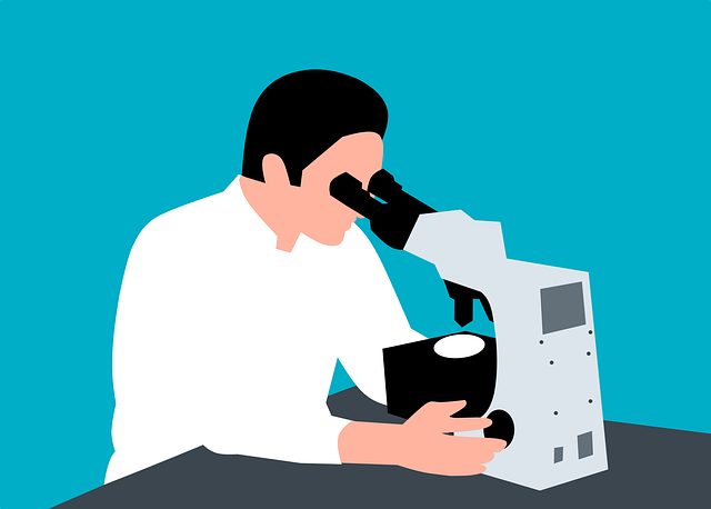 Scientist looking through microscope