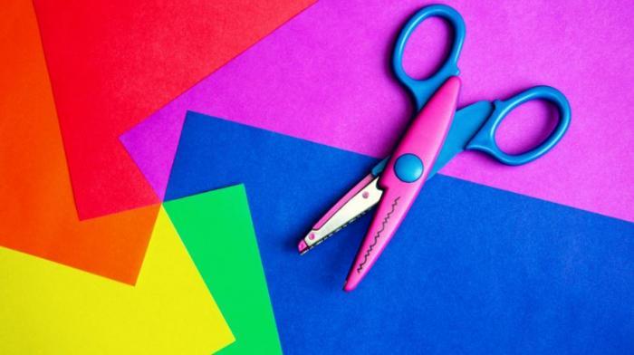 scissors sitting on pieces of coloured paper