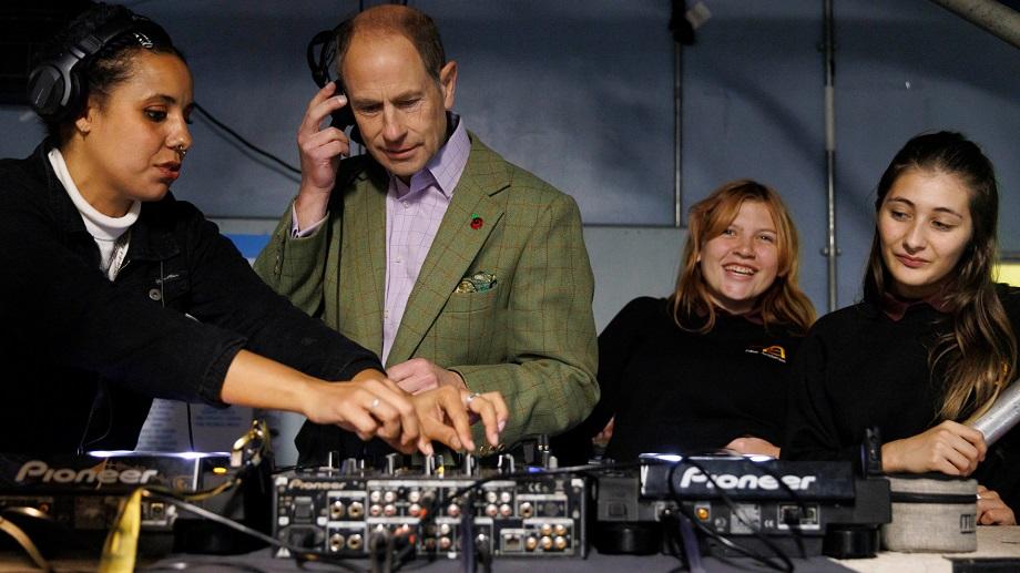 Duke of Edinburgh with headphones and crew members at the sounddesk