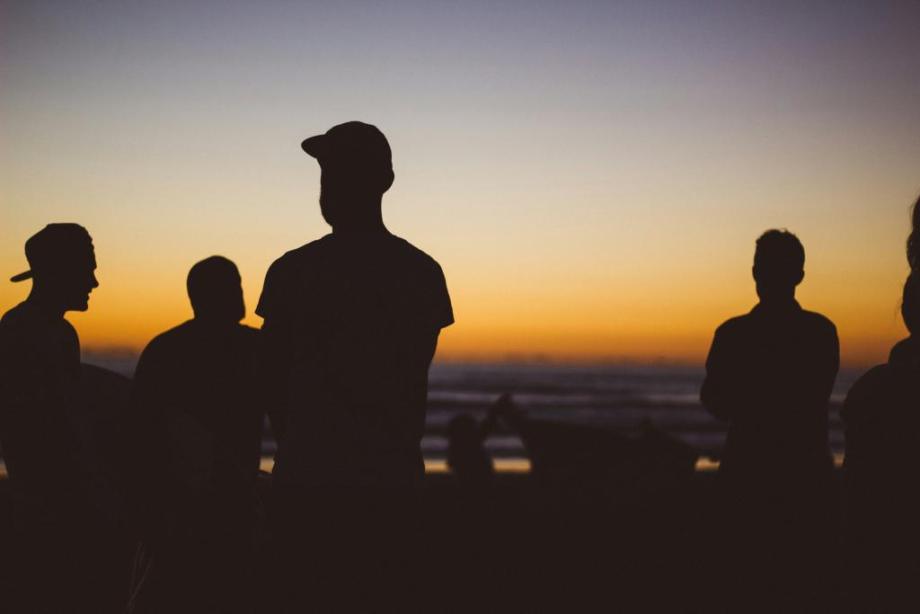 Silhouette of men at sunset 