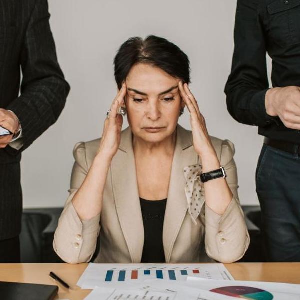 Photo showing stressed woman holding her head