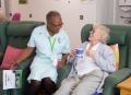 Barbara, a Healthcare Assistant at Arthur Rank Hospice Charity has a giggle with a patient receiving support from their Living Well Service.  